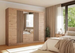 Mallorca 250cm wardrobe in Oak Artisan with mirrored centre doors and black slatted sliding panels in a bedroom