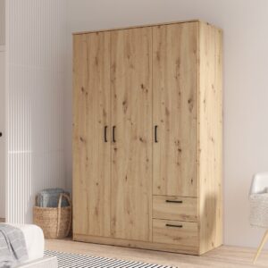 Niko 3 door wardrobe with drawers in Artisan Oak with black handles in a bedroom